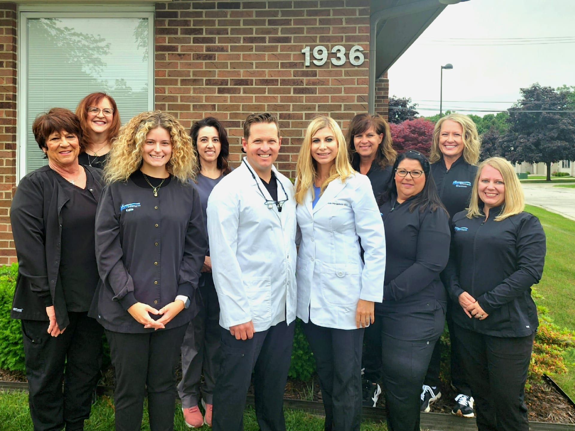 The Family Dentists, PLLC team standing together outside their Port Huron office